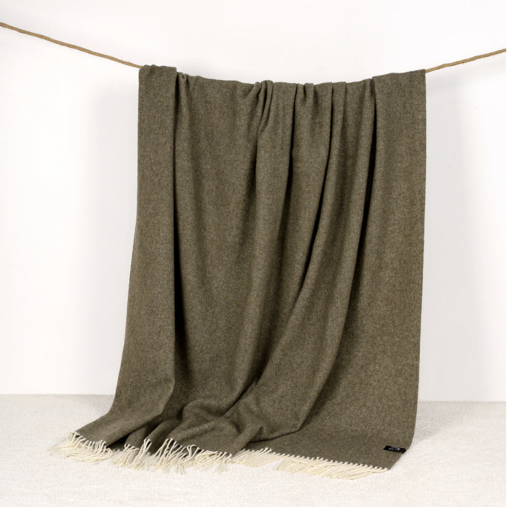 Forset  Green wool blanket hanging over a rope