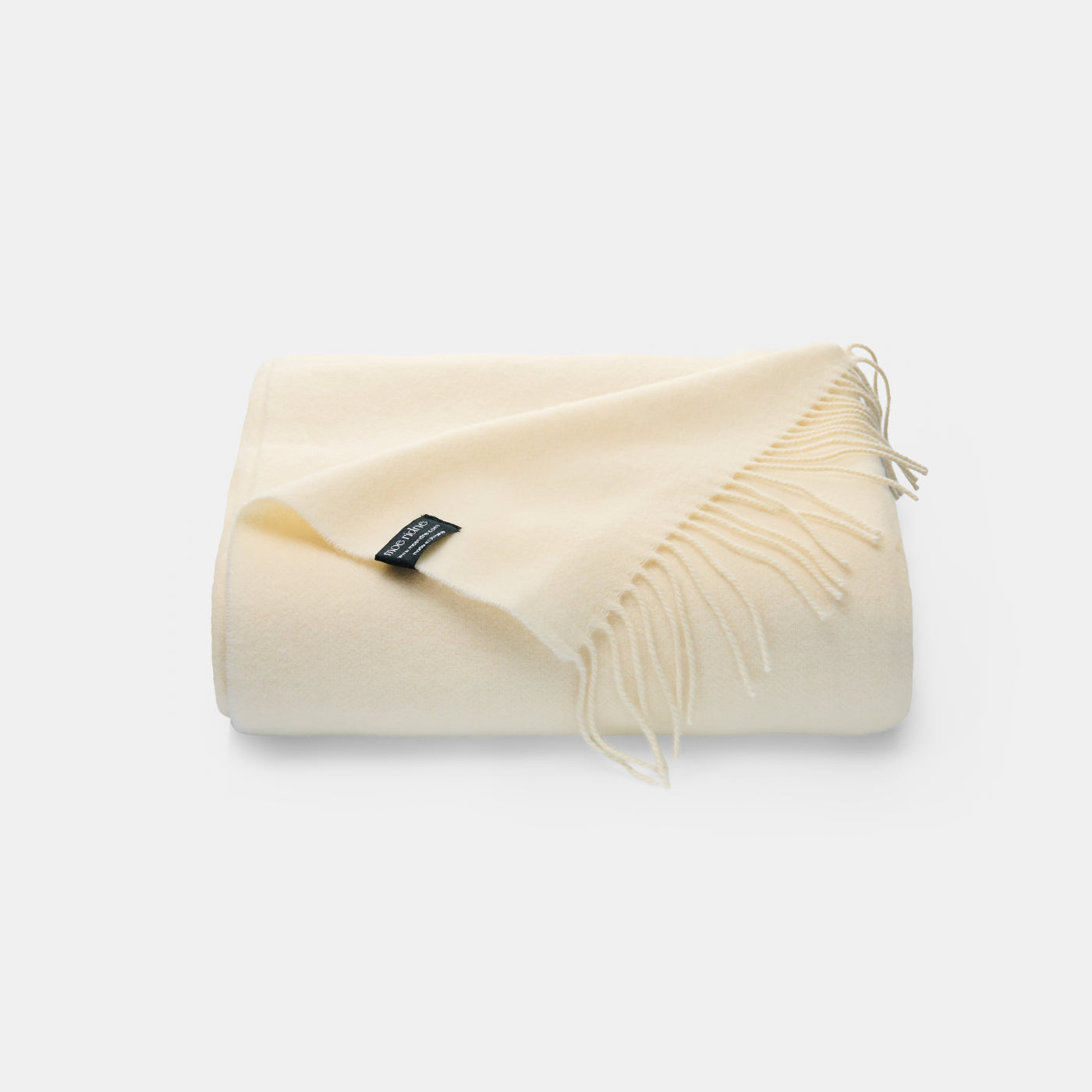 Cream cashmere merino blanket with fringe 140 x 200cm. Soft and lightweight perfect for a living room or bedroom 