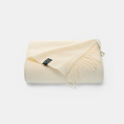 Cream cashmere merino blanket with fringe 140 x 200cm. Soft and lightweight perfect for a living room or bedroom 