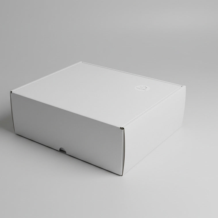 White gift box with a logo on a white carpet