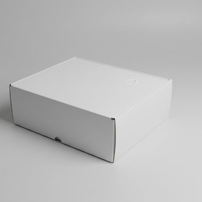 White gift box with a logo on a white carpet