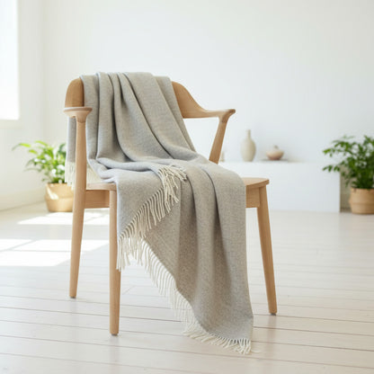 Beige wool throw draping from a wooden chair 